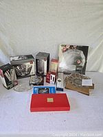 Overview of the lot showing all boxes and loose items including crystal, glass, and porcelain serving pieces and decor