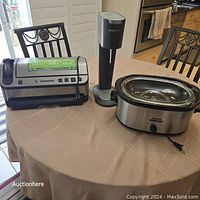 Photo of the vacuum sealer, SodaStream, and Rival slow cooker on a table.