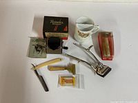 Overview of all vintage men's grooming items including Twinplex stropper, Thomas Turner straight razor, electric clipper, safety razor, Minora blades, shaving mug and Gillette blade case.