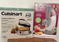 Photo of boxed Cuisinart waffle iron and Magic Bullet Dessert Bullet side by side.