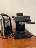 Photo showing the espresso machine and Hamilton Beach can opener placed side by side on a surface.