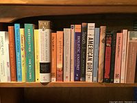 Books on a shelf showing a variety of titles and subjects including anatomy, enlightenment, literature, and history.