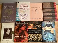 Photo showing all nine books laid out on a flat surface, titles clearly visible.