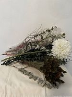 Full view of assorted dry flowers including large white chrysanthemum, eucalyptus, dried seed pods, and delicate dried white flowers