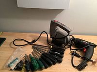 Overview of all tools in the lot including electric saver saw, hand drill, and assortment of screwdrivers.