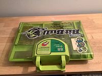 Closed green plastic carrying case with Bit Bull logo and labels