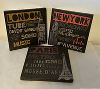 Three canvas wall art pieces for London, New York, and Paris with city-themed typography and landmarks.