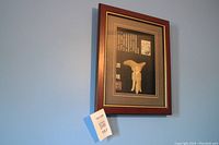 Overall view of the framed jade carving with identification card, showing size and presentation.