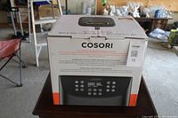 Photo of the front of the unopened Cosori air fryer box showing the digital control panel model image and product name.