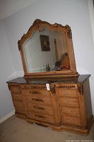 Full view of the dresser and attached mirror in a room corner, showing the overall size and style.