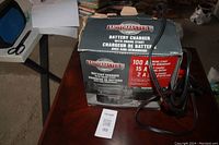 Motomaster battery charger box front showing logo, product type and main features.