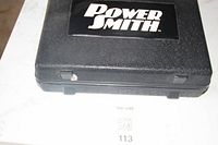Closed view of black plastic carrying case with Power Smith logo.