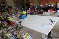 Working table with marble-like surface showing top and workspace area with surrounding items for scale.