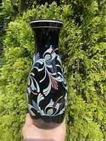 Front view of hand-painted black amethyst glass vase showing floral design