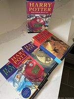 Photo of the boxed set with four Harry Potter books displayed outside the box showing the colorful illustrated covers and boxed set matching design.