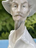 Close-up of the figure's face showing detailed facial features including a goatee, mustache, and hat.