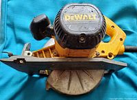 Top view showing the motor housing and yellow handle of the DeWalt circular saw with DeWalt branding visible.