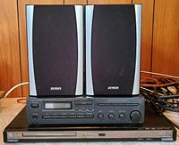 Two Jensen Champion 110 speakers placed on top of Panasonic S-533 CD/DVD player, all in good cosmetic condition, showing front panel and speaker grills