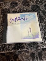 Photo of the Genesis 'We Can't Dance' music CD in its jewel case showing the front album cover artwork.