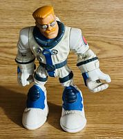 Single plastic action figure of Warren Waters from Rescue Heroes, posed standing on wooden surface.