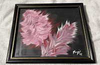 Framed print showing stylized pink flowers, signed by Magni 1995 in bottom right corner, mounted in black frame with gold accent.