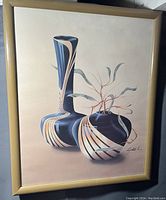 Full view of the signed framed print showing two abstract vases with a plant and a beige frame.
