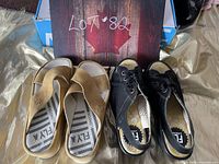 Photo showing both pairs of Fly London shoes, taupe sandals and black wedge shoes.