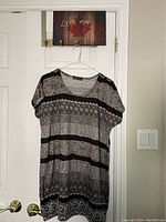 Front view of Maccine shirt/dress hanging on a hanger showing overall condition and pattern details.