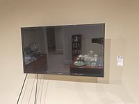 Front view of Samsung flat screen TV mounted on wall.