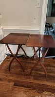 Pair of wooden folding TV trays side by side showing overall condition and style