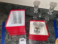 Two Waterford crystal candlesticks and Baccarat crystal sugar bowl in original red boxes with foam padding.