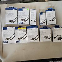 Full lot of Insignia branded video cables and adapters laid out, clearly showing boxes and labels for each cable type and adapter.