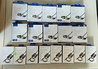 Photo showing 10 Insignia HDMI to DVI-D cables in retail packaging and 8 Insignia 3.5mm universal FM transmitters in retail packaging arranged neatly on a white surface.