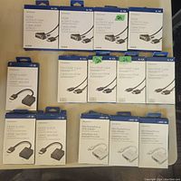 Image showing all visible Insignia branded cables and adapters in their original packaging, arranged in rows. Includes HDMI to DVI-D cables, mini HDMI to HDMI cables, HDMI to VGA adapters, and mini DisplayPort to VGA adapters.