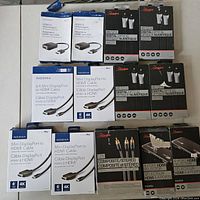 Top-down view of all boxed cables and adapters laid flat on a surface, showing brands and cable types.