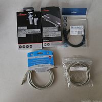 Photo showing all five cables and HDMI selector boxes and packages clearly laid out on a white surface.