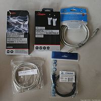 Photo showing all five cables in their respective packaging or bags, displaying brand names and cable types.