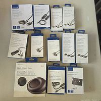 Photo displaying all Insignia branded electronics cables and adapters in original packaging neatly arranged on a surface.