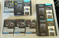 Seven TV wall mounts displayed in original boxes, including three Rocketfish RF-TVMLPT01V2-C mounts and four Wallwizard TM37 mounts, some with missing pieces.