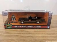 Front view of the new in box Batmobile with Batman figure, showing packaging and product.