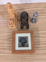 Overview of all four Egyptian decorative items on a wooden surface