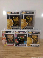Photo of all five Funko Pop boxes showing Ant-Man, Black Widow, Firestorm, Gamora, and Doctor Strange figures.