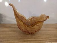Photo of amber marbled crystal bowl showing flowing wavy edges and overall shape