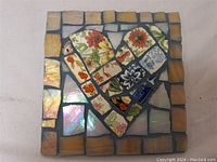 Full view of a 6 inch square mosaic artwork featuring a heart shape made of ceramic and porcelain tile shards with floral motifs.