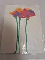 Full view of the artwork showing three stylized flowers with colorful petals on handmade paper.