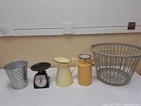 Photo showing whole lot: laundry basket, kitchen scale, cream pitcher, yellow milk tin, and perforated metal holder.