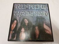 Front cover of Deep Purple's Machine Head LP showing band members and embossed album title, with some edge wear visible.