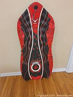 Front view of the Sno-Storm Rocks slider sled showing the overall shape, size, and design colors.