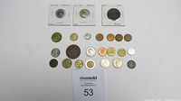 Full lot of foreign coins including restamped Roman replicas and various other international coins
