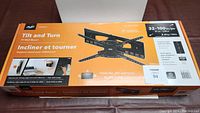 Box packaging of AVF Tilt and Turn TV Wall Mount showing specifications for 32 to 100 inch TVs, maximum load 80 kg, with model details and features.